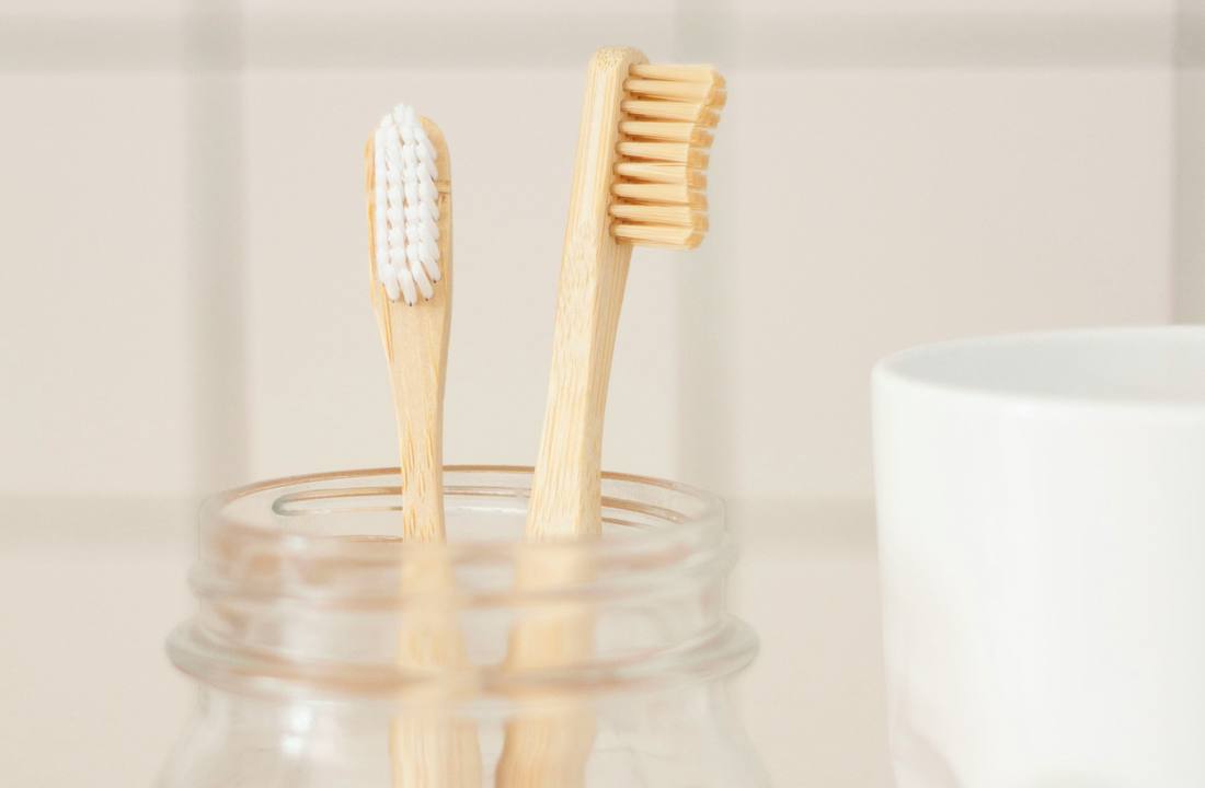 Holding the Better and Better bamboo toothbrush to show grip and handle shape
